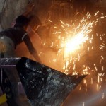 Workers try to cut through an iron slab after a fire broke out at Dudhsagar dairy in Mehsana district