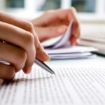 Close-up of secretary’s hands doing paperwork