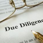 page-of-paper-with-words-due-diligence-and-glasses