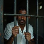 prisoner_looking_out_window_parole_india